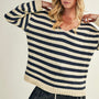 Woman wearing a striped sweater with a neutral background