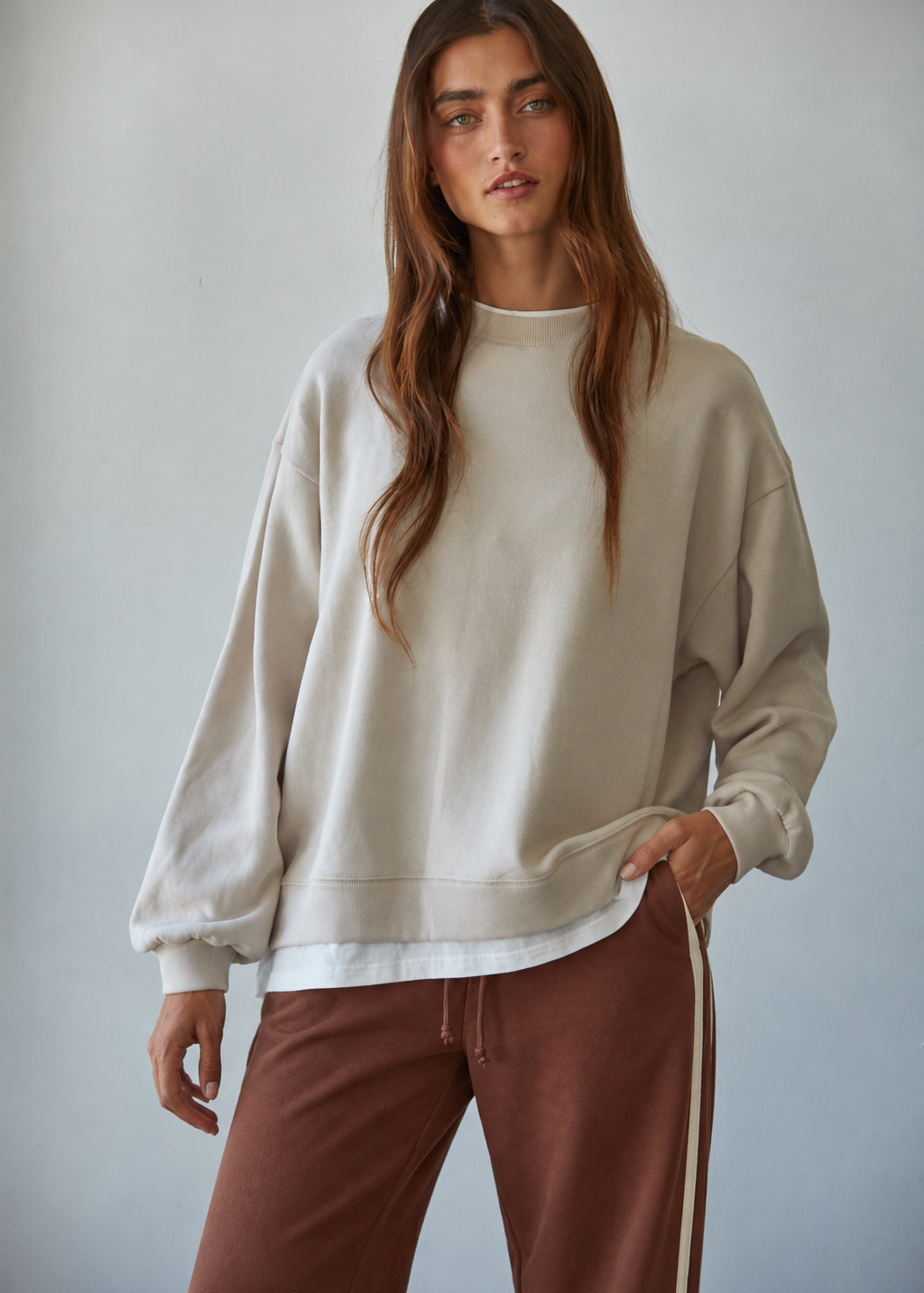 Front view of the Jetset cream crewneck sweatshirt with dropped shoulders and white trim at the neckline and hem.