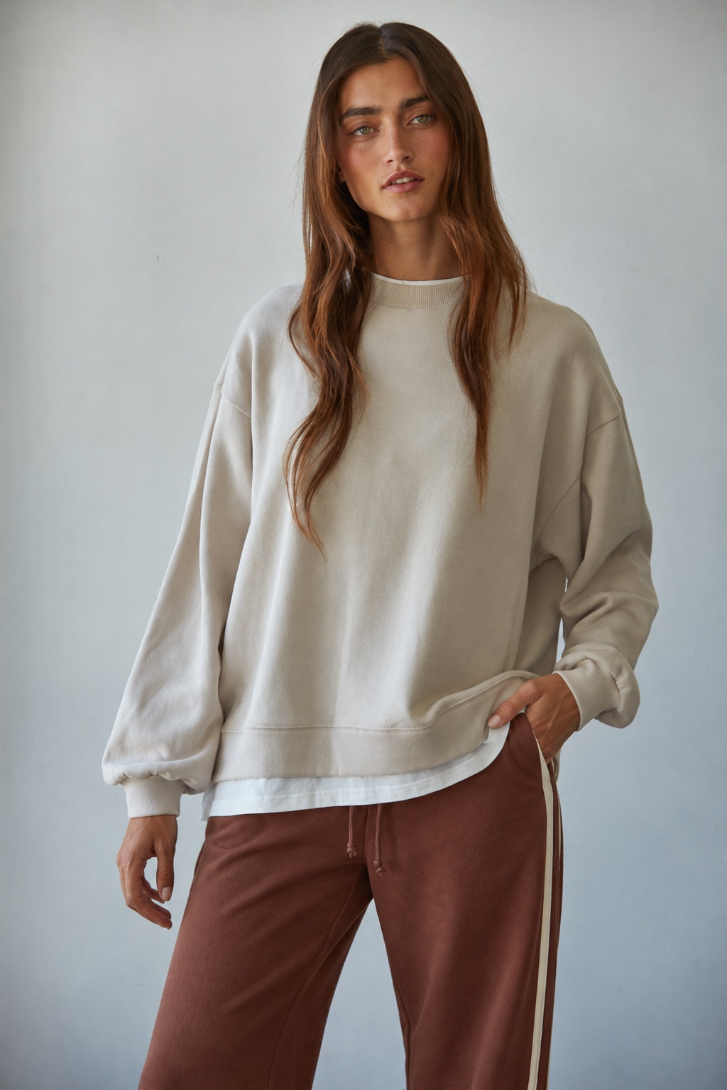 Front view of the Jetset cream crewneck sweatshirt with dropped shoulders and white trim at the neckline and hem.