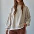 Front view of the Jetset cream crewneck sweatshirt with dropped shoulders and white trim at the neckline and hem.