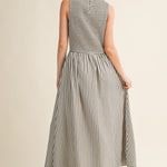 Back view of Darcy Smocked Stripe Maxi Dress in black and ivory stripe, featuring a smocked bodice, sleeveless cut, and relaxed maxi-length skirt.