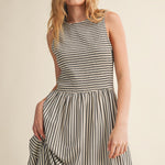 Close-up of Darcy Smocked Stripe Maxi Dress in black, featuring a textured smocked bodice, sleeveless design, and flowing striped maxi skirt.