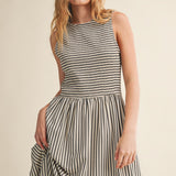 Close-up of Darcy Smocked Stripe Maxi Dress in black, featuring a textured smocked bodice, sleeveless design, and flowing striped maxi skirt.