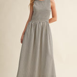 Darcy Smocked Stripe Maxi Dress in black and ivory stripe, full-length front view with sleeveless smocked bodice and side pockets.