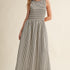 Darcy Smocked Stripe Maxi Dress in black and ivory stripe, full-length front view with sleeveless smocked bodice and side pockets.
