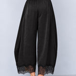 Back view of Daydream black satin barrel pants with lace-trimmed hems