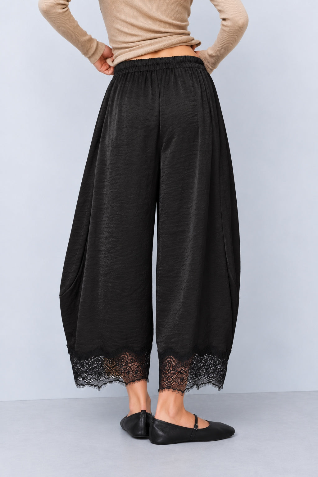 Back view of Daydream black satin barrel pants with lace-trimmed hems