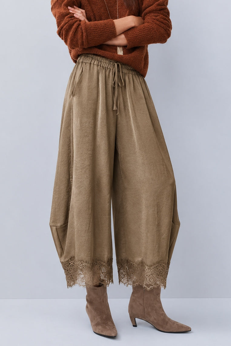 Front view of Daydream olive lace-trim satin barrel pants styled with a brown top and heels