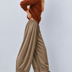 Side view of Daydream olive satin barrel pants with lace-trimmed hems