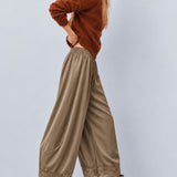 Side view of Daydream olive satin barrel pants with lace-trimmed hems
