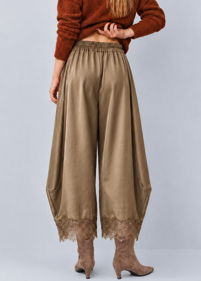 Back view of Daydream olive satin barrel pants showing the relaxed fit and lace hems