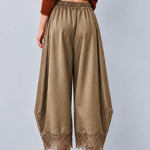 Back view of Daydream olive satin barrel pants showing the relaxed fit and lace hems