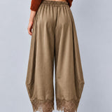 Back view of Daydream olive satin barrel pants showing the relaxed fit and lace hems