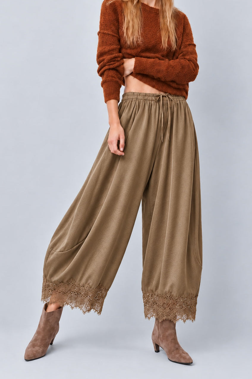 Daydream olive lace-trim satin pants paired with a fitted brown top and heels