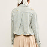 Back view of distressed hem striped denim jacket with pleated back detail