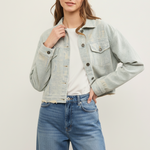 Front view of distressed hem striped denim jacket styled casually in sand wash