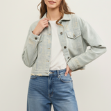 Front view of distressed hem striped denim jacket styled casually in sand wash