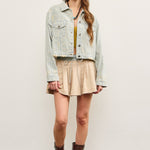 Full body view of distressed hem striped denim jacket styled with skirt