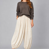 Front view of women’s beige striped satin balloon pants with a relaxed bubble-leg shape