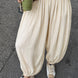 Woman styling the Double Bubble striped satin balloon pants in beige