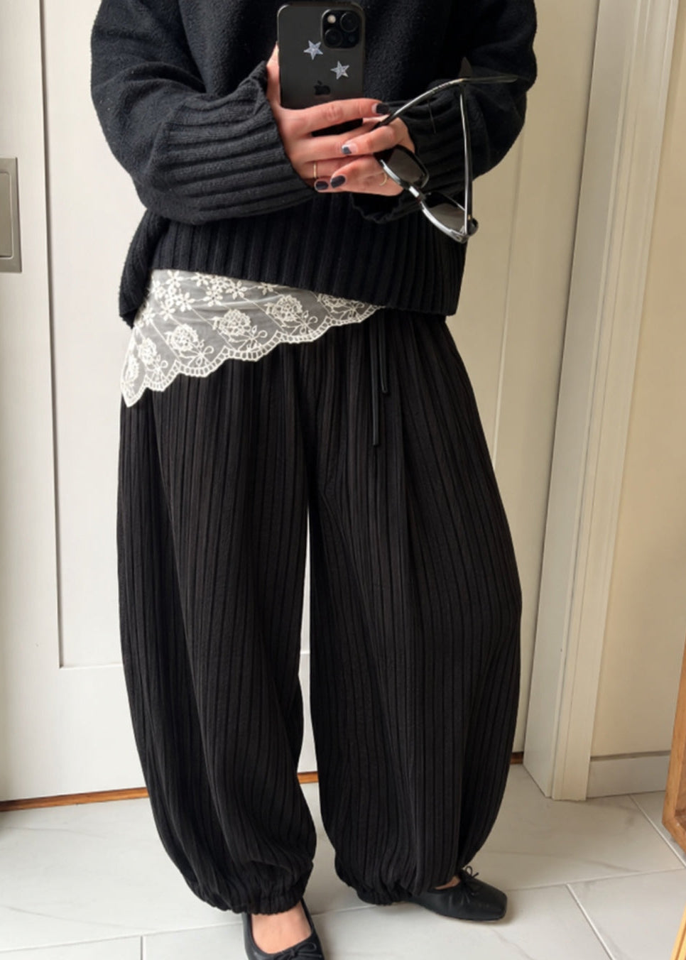 Woman styling the Double Bubble striped satin balloon pants in black