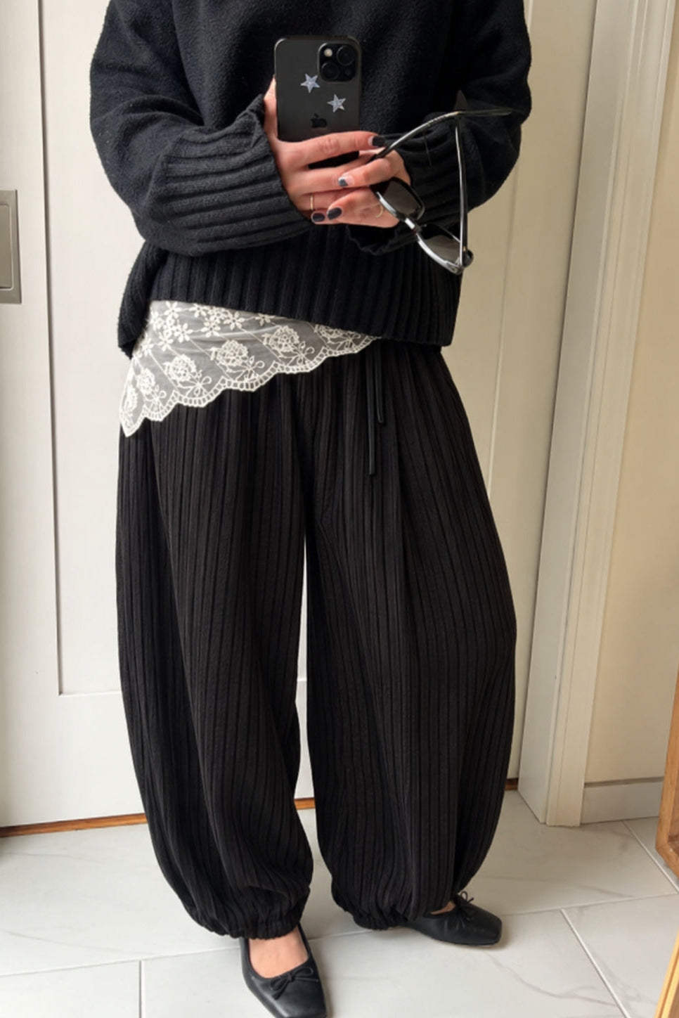 Woman styling the Double Bubble striped satin balloon pants in black