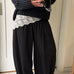 Woman styling the Double Bubble striped satin balloon pants in black