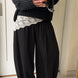 Woman styling the Double Bubble striped satin balloon pants in black