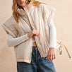 Woman wearing an ecru puffer vest with quilted texture and relaxed fit — cozy women’s outerwear for fall layering.