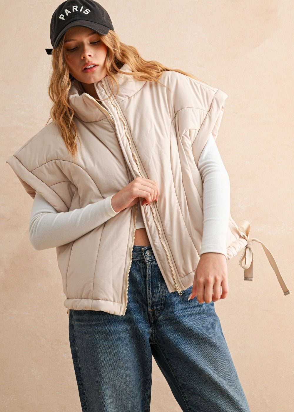 Woman wearing an ecru puffer vest with quilted texture and relaxed fit — cozy women’s outerwear for fall layering.