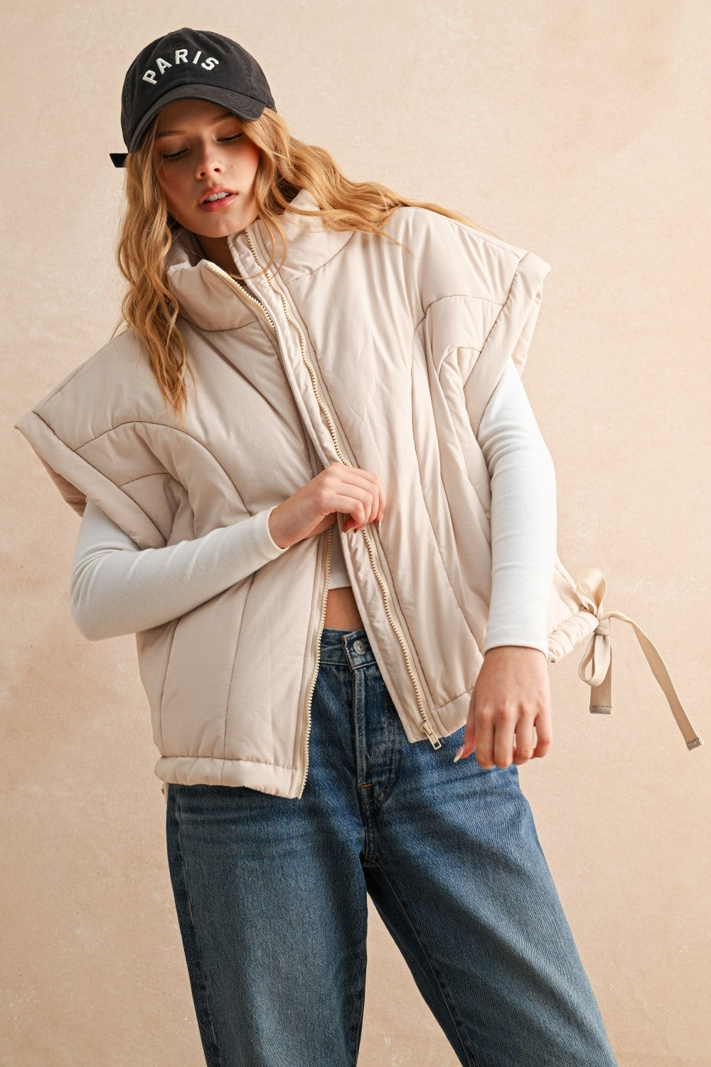 Woman wearing an ecru puffer vest with quilted texture and relaxed fit — cozy women’s outerwear for fall layering.