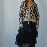 Feline Leopard Print Tie Cardigan in mocha black styled with a black skirt, full body front view