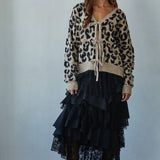 Feline Leopard Print Tie Cardigan in mocha black styled with a black skirt, full body front view