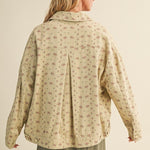 Back view of the taupe floral jacket highlighting pleated back detail