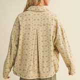 Back view of the taupe floral jacket highlighting pleated back detail