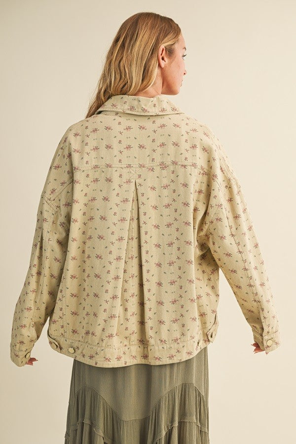 Back view of the taupe floral jacket highlighting pleated back detail