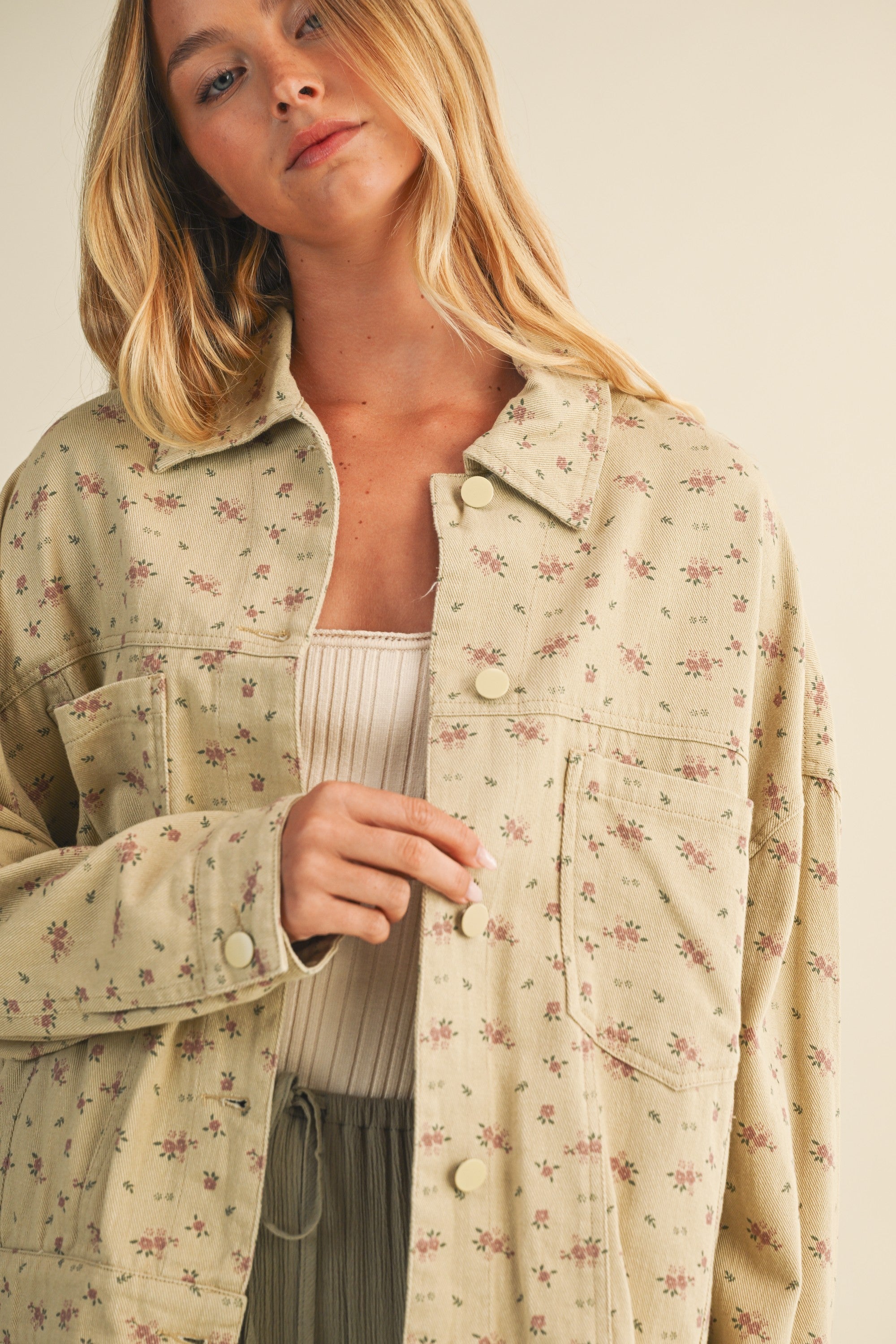 Close-up front view of the taupe floral cotton jacket showing print and button details