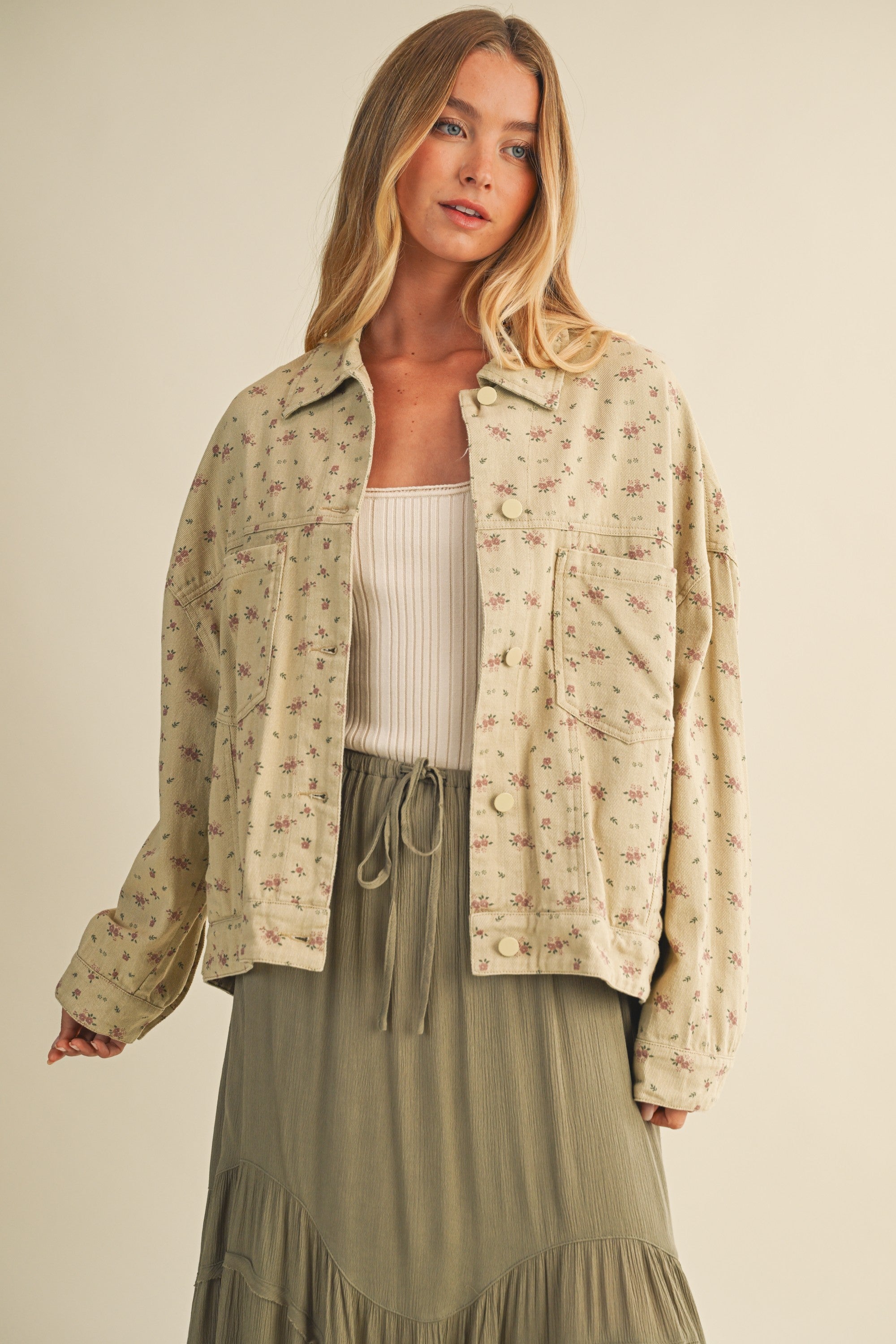 Styled front view of the Floral Back-Pleated Cotton Jacket in taupe layered over a dress