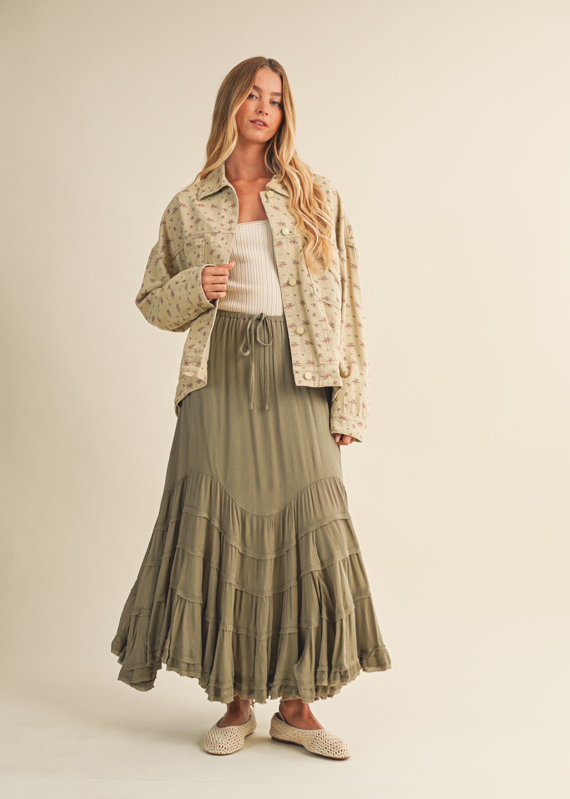 Full-body view of the Floral Back-Pleated Cotton Jacket in taupe styled with a skirt