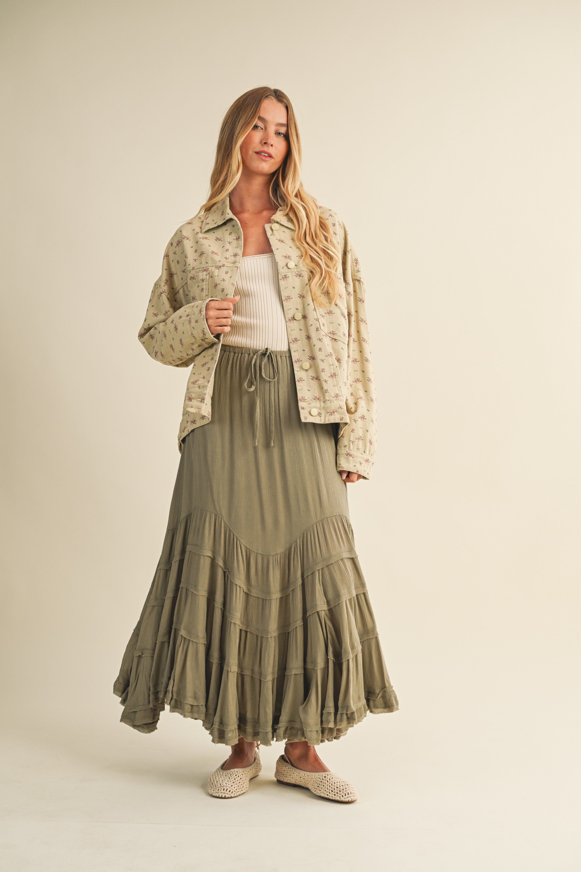 Full-body view of the Floral Back-Pleated Cotton Jacket in taupe styled with a skirt