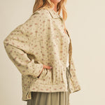Side view of the taupe cotton jacket showing relaxed fit and side pocket