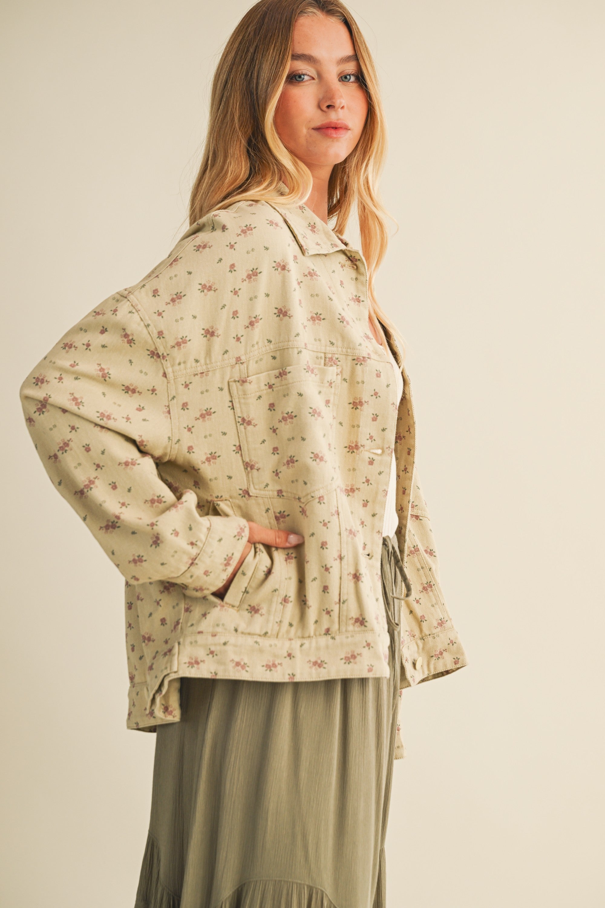 Side view of the taupe cotton jacket showing relaxed fit and side pocket