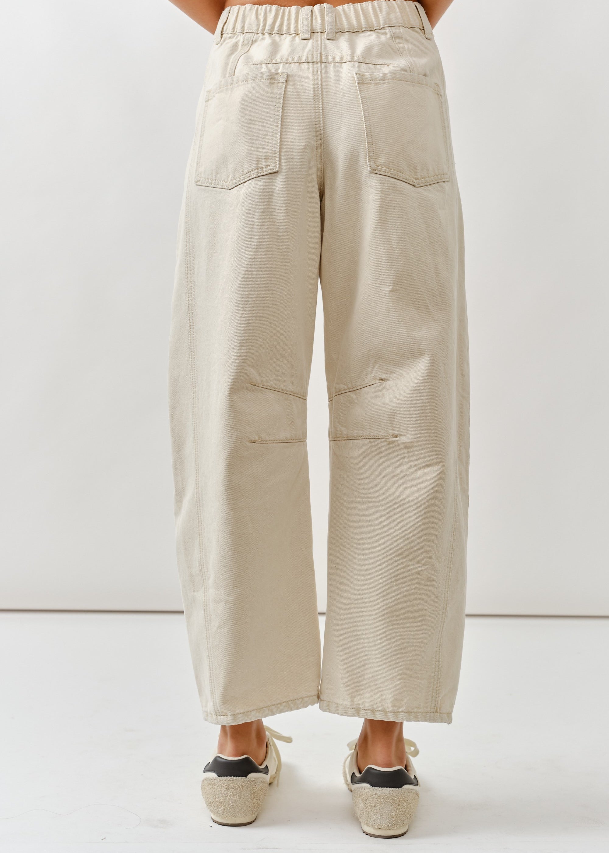 Beige wide-leg pants worn by a person on a white background