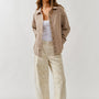 Front lifestyle view of model wearing Floral Embroidered Barrel Leg Jeans in beige