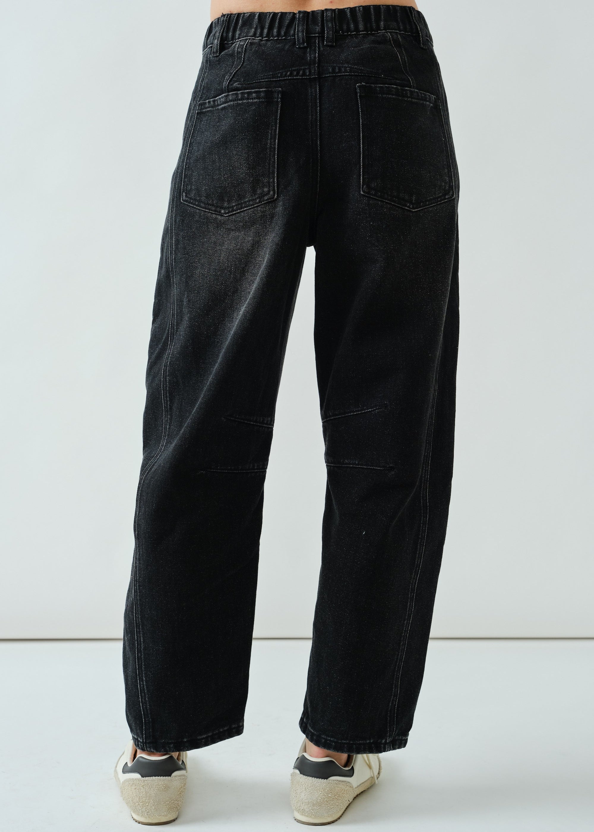 Back view of the faded black barrel-leg jeans