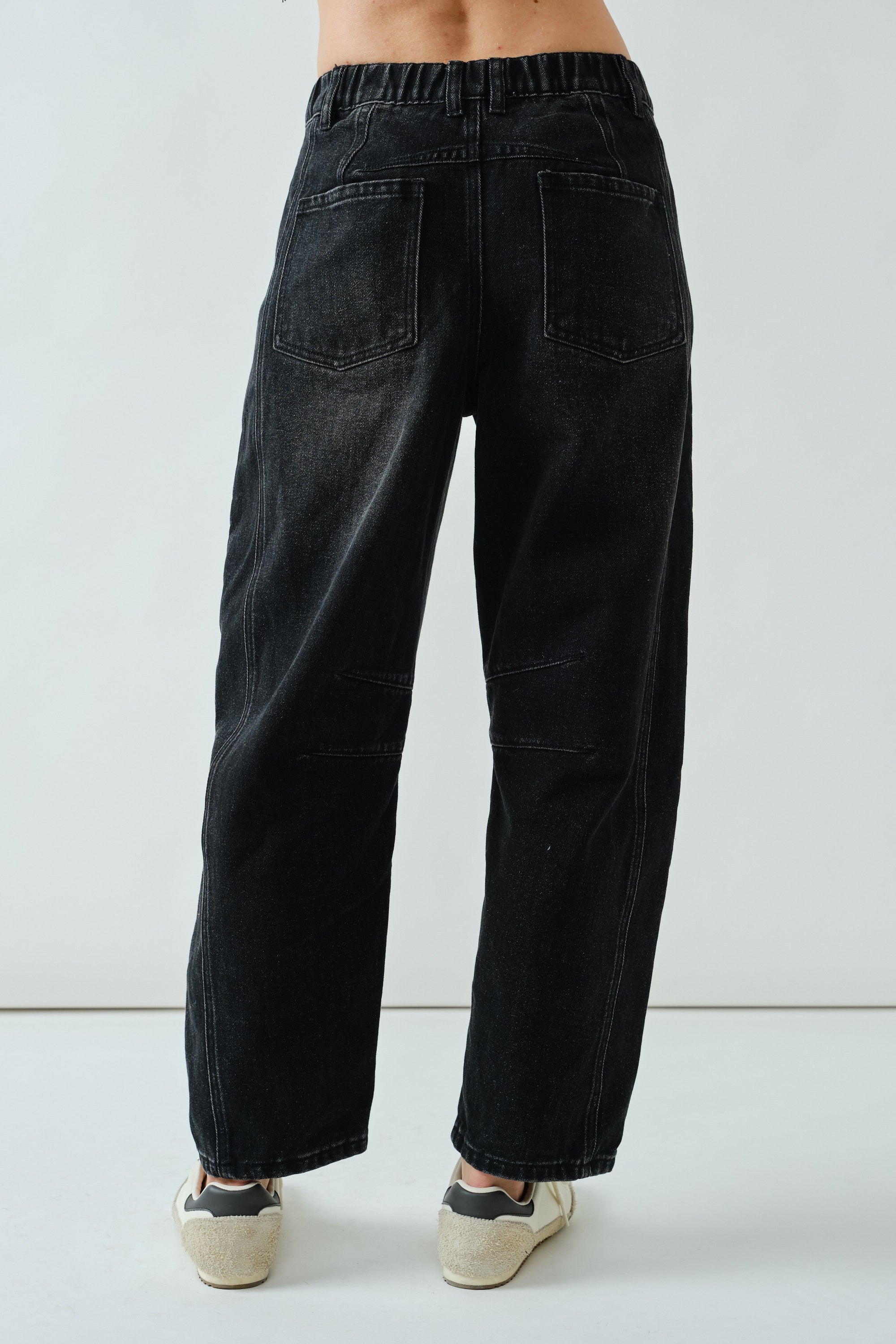 Back view of the faded black barrel-leg jeans