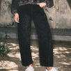 Front lifestyle view of model wearing Floral Embroidered Barrel Leg Jeans in faded black