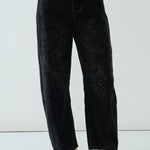 Front view of the faded black barrel-leg jeans showing relaxed fit