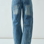 Back view of the medium wash embroidered barrel-leg jeans