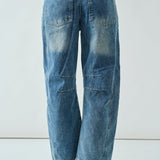 Back view of the medium wash embroidered barrel-leg jeans